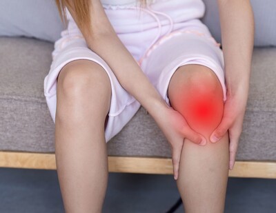 Woman holding her knee due to pain