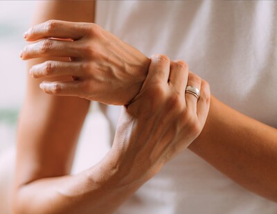 Woman holding her wrist due to pain